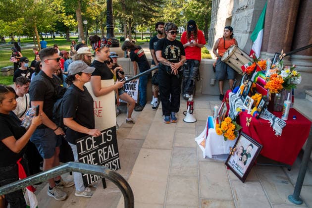 July 18, 2026, Salt Lake City, Utah, USA: Protesters gather near a temporary altar featuring flowers and photographs of various victims outside the Salt Lake City and County Building at Washington Square Park during an ICE OUT protest in Salt Lake City, Utah, on Saturday, July 18, 2026. The demonstration was organized to contest immigration policy following the recent fatal shootings of Lorenzo Salgado Araujo and Joan Sebastian Guerrero by federal immigration law enforcement agents. Salt Lake City USA  - ZUMAm292 20260718_znp_m292_012 Copyright: xCharlesxMcClintockxWilsonx
