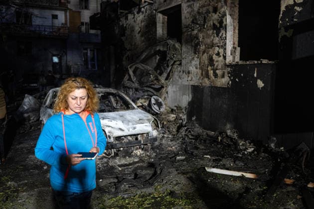A woman walks past a burnt-out car and a building in the Solomianskyi district after a Russian attack on Kyiv, Ukraine, July 19, 2026. The Russian army launched a massive strike on the Ukrainian capital with ballistic missiles. According to preliminary data from the State Emergency Service of Ukraine, one person was killed and 15 were injured. Falling debris and fires were reported in five districts of the city, while an underpass near the Lukianivska metro station sustained a direct hit. (Photo by Danylo Antoniuk Ukrinform) Russian army attack Kyiv with ballistic missiles  Copyright: xDanyloxAntoniukx