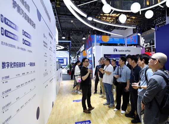 (260719) -- SHANGHAI, July 19, 2026 -- Visitors learn about the digital intelligence management across the entire industry chain at the booth of Luckin Coffee during the 2026 World AI Conference and High-Level Meeting on Global AI Governance in Shanghai, east China, July 19, 2026. The event scheduled from Friday to Monday showcases exhibitions of a number of AI agent hardware and system products, highlighting the transition of next-generation AI from a tool to an intelligent partner, empowering various industries and everyday life. ) CHINA-SHANGHAI-WORLD AI CONFERENCE-AI PRODUCTS (CN) LiuxYing 