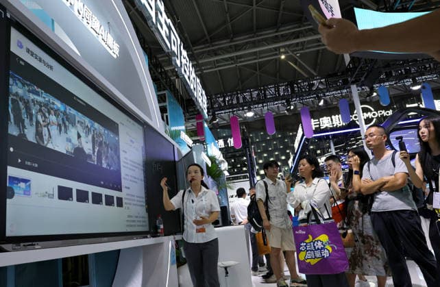 (260719) -- SHANGHAI, July 19, 2026 -- A staff member (L) introduces functions of the iFlytek AI blackboard during the 2026 World AI Conference and High-Level Meeting on Global AI Governance in Shanghai, east China, July 19, 2026. The event scheduled from Friday to Monday showcases exhibitions of a number of AI agent hardware and system products, highlighting the transition of next-generation AI from a tool to an intelligent partner, empowering various industries and everyday life. ) CHINA-SHANGHAI-WORLD AI CONFERENCE-AI PRODUCTS (CN) FangxZhe 