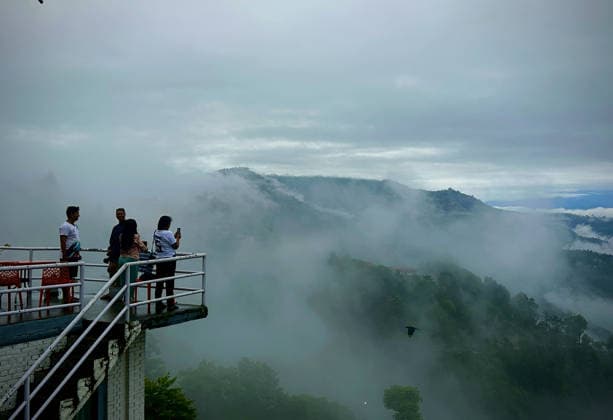 July 19, 2026, Kathmandu, Nepal: Visitors capture the misty morning after continuous rainfall, as clouds drape the surrounding hills in a serene monsoon landscape in Dhulikhel, Kavrepalanchok, on the outskirts of Kathmandu, Nepal on July 19, 2026. Kathmandu Nepal  - ZUMAs233 20260719_zap_s233_003 Copyright: xSunilxSharmax
