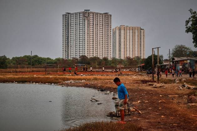 July 19, 2026, Jakarta, Indonesia: JAKARTA, INDONESIA Ã¢â‚¬ JULY 19, 2026: Children sit and play outside a house in Kampung Muara Baru, North Jakarta. According to the Jakarta Public Housing and Settlement Agency (DPRKP), high population density, limited land for infrastructure development, zoning constraints and land tenure issues remain among the main challenges to improving informal settlements in the Indonesian capital. JNA Press Jakarta Indonesia - ZUMAq101 20260719_zna_q101_085 Copyright: xMuhammadxRizkyxFebriansyahx