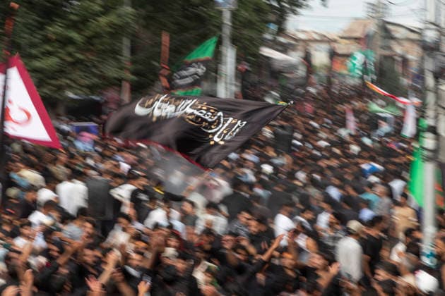 July 19, 2026, Budgam, Jammu And Kashmir, India: A Shiite Muslim waves a religious flag during a procession on the fourth day of Safar in Magam. Safar, the second month of the Islamic calendar, follows Muharram and continues the mourning of Imam Hussain. According to Shia tradition, the 4th of safar, 61 AH, marks the imprisonment of the Prophet s household (Ahl al-Bayt) in Kufa under the orders of Ubaydullah ibn Ziyad after the Battle of Karbala. Budgam India - ZUMAa205 20260719_zip_a205_002 Copyright: xAdilxAbassx