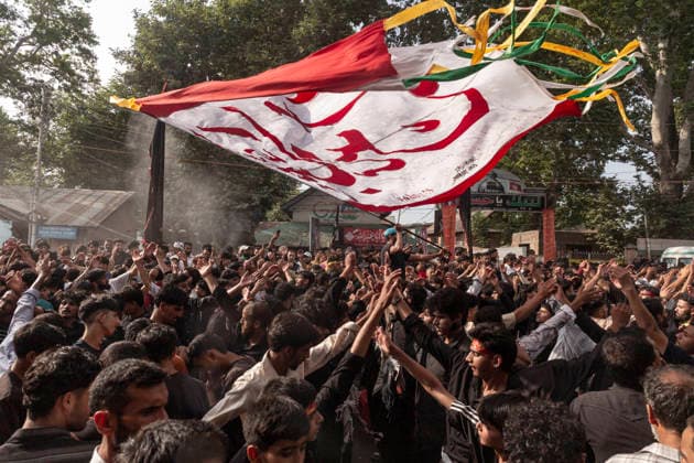 July 19, 2026, Budgam, Jammu And Kashmir, India: A Shiite Muslim waves a religious flag during a procession on the fourth day of Safar in Magam. Safar, the second month of the Islamic calendar, follows Muharram and continues the mourning of Imam Hussain. According to Shia tradition, the 4th of safar, 61 AH, marks the imprisonment of the Prophet s household (Ahl al-Bayt) in Kufa under the orders of Ubaydullah ibn Ziyad after the Battle of Karbala. Budgam India - ZUMAa205 20260719_zip_a205_004 Copyright: xAdilxAbassx