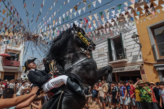 July 19, 2026, Es Mercadal, Menorca Balearic Islands, Spain: A caixer, or horse rider, rears his horse amid a cheering crowd during the traditional Jaleo at the Sant MartoÂ­ Festival in Es Mercadal. Es Mercadal Spain - ZUMAo105 20260719_fap_o105_016 Copyright: xMatthiasxOesterlex