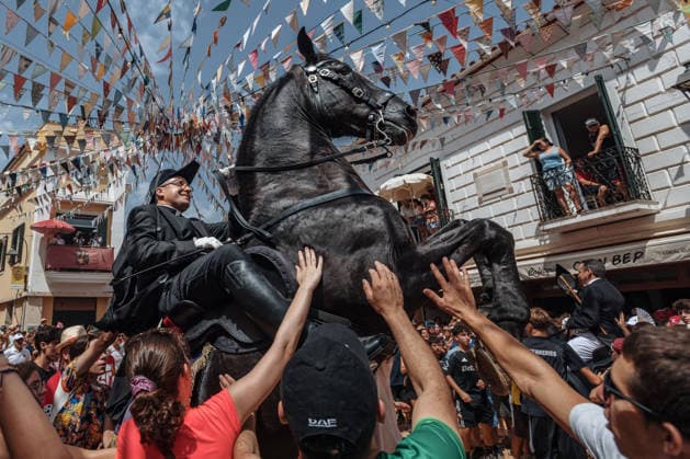 July 19, 2026, Es Mercadal, Menorca Balearic Islands, Spain: A caixer, or horse rider, rears his horse amid a cheering crowd during the traditional Jaleo at the Sant MartoÂ­ Festival in Es Mercadal. Es Mercadal Spain - ZUMAo105 20260719_fap_o105_023 Copyright: xMatthiasxOesterlex