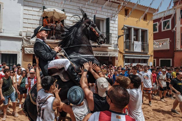 July 19, 2026, Es Mercadal, Menorca Balearic Islands, Spain: A caixer, or horse rider, rears his horse amid a cheering crowd during the traditional Jaleo at the Sant MartoÂ­ Festival in Es Mercadal. Es Mercadal Spain - ZUMAo105 20260719_fap_o105_032 Copyright: xMatthiasxOesterlex