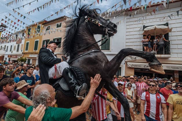July 19, 2026, Es Mercadal, Menorca Balearic Islands, Spain: A caixer, or horse rider, rears his horse amid a cheering crowd during the traditional Jaleo at the Sant MartoÂ­ Festival in Es Mercadal. Es Mercadal Spain - ZUMAo105 20260719_fap_o105_033 Copyright: xMatthiasxOesterlex