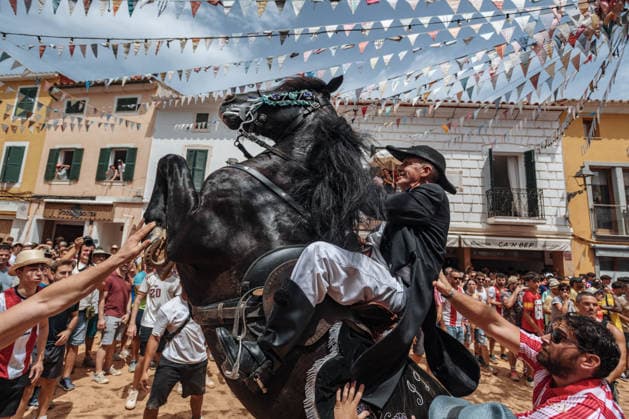 July 19, 2026, Es Mercadal, Menorca Balearic Islands, Spain: A caixer, or horse rider, rears his horse amid a cheering crowd during the traditional Jaleo at the Sant MartoÂ­ Festival in Es Mercadal. Es Mercadal Spain - ZUMAo105 20260719_fap_o105_034 Copyright: xMatthiasxOesterlex