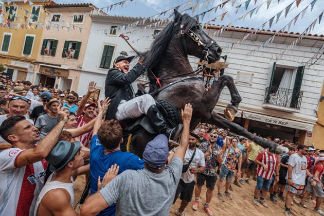 July 19, 2026, Es Mercadal, Menorca Balearic Islands, Spain: A caixer, or horse rider, rears his horse amid a cheering crowd during the traditional Jaleo at the Sant MartoÂ­ Festival in Es Mercadal. Es Mercadal Spain - ZUMAo105 20260719_fap_o105_030 Copyright: xMatthiasxOesterlex