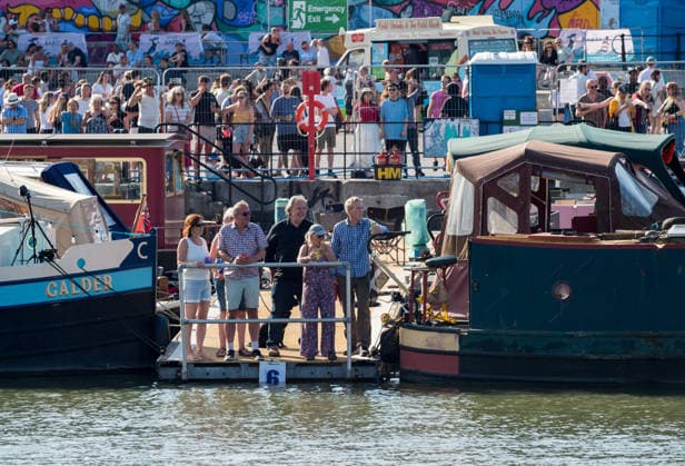 July 19, 2026, Bristol, Bristol, UK: Bristol, UK. People watch the boat parade at Bristol Harbour Festival in warm weather at the end of the latest summer heatwave in the UK. The event includes maritime displays and boats and ships with music, circus and other performances. Bristol UK  - ZUMAl94_ 20260719_zaf_l94_018 Copyright: xSimonxChapmanx