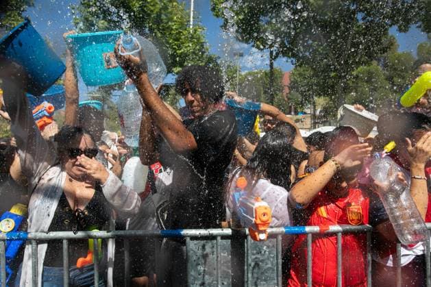 July 19, 2026, Madrid, Madrid, Spain: Participants in the Vallecas Water Battle get soaked.during the Water Battle in the working-class neighborhood of Vallecas, Madrid. This celebration began in 1981 due to the high temperatures, when residents started throwing water at each other. It is also part of the festivities for the Virgen del Carmen, patron saint of sailors. Madrid Spain - ZUMAs197 20260719_aaa_s197_131 Copyright: xDavidxCanalesx