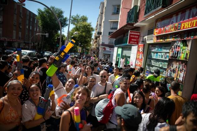 July 19, 2026, Madrid, Madrid, Spain: Participants in the Vallecas Water Battle are seen on a street in the neighborhood.during the Water Battle in the working-class neighborhood of Vallecas, Madrid. This celebration began in 1981 due to the high temperatures, when residents started throwing water at each other. It is also part of the festivities for the Virgen del Carmen, patron saint of sailors. Madrid Spain - ZUMAs197 20260719_aaa_s197_138 Copyright: xDavidxCanalesx