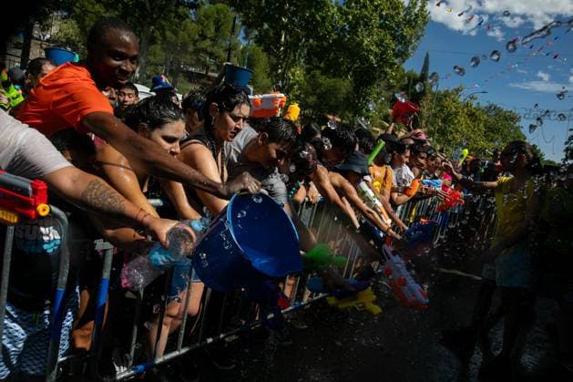 July 19, 2026, Madrid, Madrid, Spain: Participants in the Vallecas Water Battle get soaked.during the Water Battle in the working-class neighborhood of Vallecas, Madrid. This celebration began in 1981 due to the high temperatures, when residents started throwing water at each other. It is also part of the festivities for the Virgen del Carmen, patron saint of sailors. Madrid Spain - ZUMAs197 20260719_aaa_s197_139 Copyright: xDavidxCanalesx