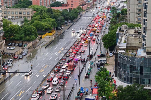 SHANGHAI, CHINA - JULY 19: Cars drive through flooded street due to heavy rainstorms on July 19, 2026 in Shanghai, China. Shanghai Meteorological Observatory upgraded the rainstorm alert from yellow to orange for the central urban area at 14:35 on July 19.  Copyright: xVCGx 111655213998