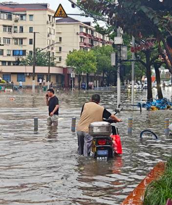 SHANGHAI, CHINA - JULY 19: A motorcyclist wades through flooded street due to heavy rainstorms on July 19, 2026 in Shanghai, China. Heavy rain caused severe waterlogging in roads and residential areas in Shanghai s Yangpu District. Shanghai Meteorological Observatory upgraded the rainstorm alert from yellow to orange for the central urban area at 14:35 on July 19.  Copyright: xVCGx 111655264429