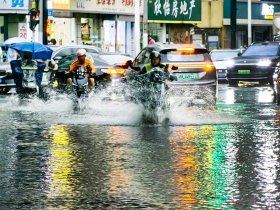 SHANGHAI, CHINA - JULY 19: Motorcyclists drive through flooded street due to heavy rainstorms on July 19, 2026 in Shanghai, China. Heavy rain caused severe waterlogging in roads and residential areas in Shanghai s Yangpu District. Shanghai Meteorological Observatory upgraded the rainstorm alert from yellow to orange for the central urban area at 14:35 on July 19.  Copyright: xVCGx 111655264432