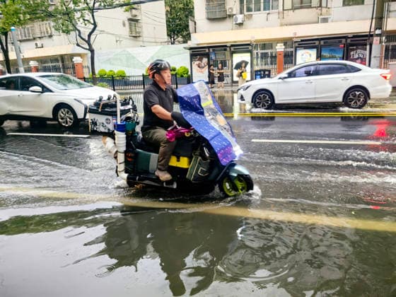 SHANGHAI, CHINA - JULY 19: A motorcyclist drives through flooded street due to heavy rainstorms on July 19, 2026 in Shanghai, China. Heavy rain caused severe waterlogging in roads and residential areas in Shanghai s Yangpu District. Shanghai Meteorological Observatory upgraded the rainstorm alert from yellow to orange for the central urban area at 14:35 on July 19.  Copyright: xVCGx 111655264433