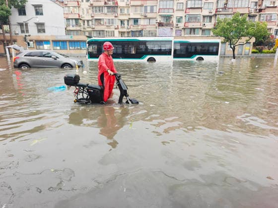 SHANGHAI, CHINA - JULY 19: A motorcyclist wades through flooded street due to heavy rainstorms on July 19, 2026 in Shanghai, China. Heavy rain caused severe waterlogging in roads and residential areas in Shanghai s Yangpu District. Shanghai Meteorological Observatory upgraded the rainstorm alert from yellow to orange for the central urban area at 14:35 on July 19.  Copyright: xVCGx 111655264426