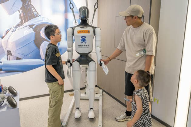 KUNSHAN, CHINA - JULY 19: People visit a robot 6S store on its opening day on July 19, 2026 in Kunshan, Jiangsu Province of China. The store offers integrated sales, spare parts, after-sales service, feedback, leasing, and customization services while serving as a hub for humanoid robots, drones, training, and industry incubation.  Copyright: xVCGx 111655192691