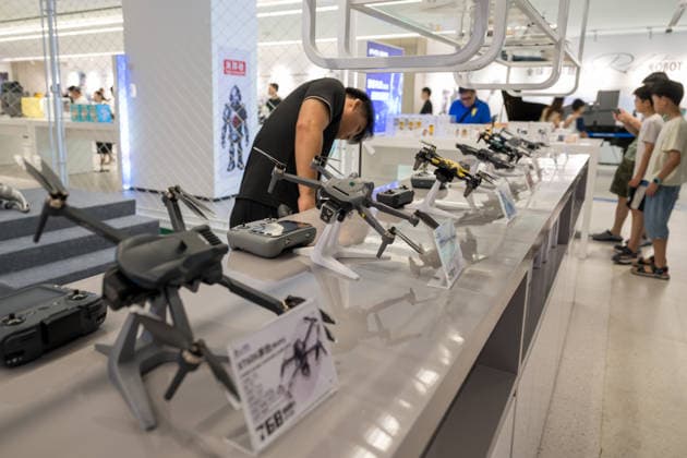 KUNSHAN, CHINA - JULY 19: People visit a robot 6S store on its opening day on July 19, 2026 in Kunshan, Jiangsu Province of China. The store offers integrated sales, spare parts, after-sales service, feedback, leasing, and customization services while serving as a hub for humanoid robots, drones, training, and industry incubation.  Copyright: xVCGx 111655192664