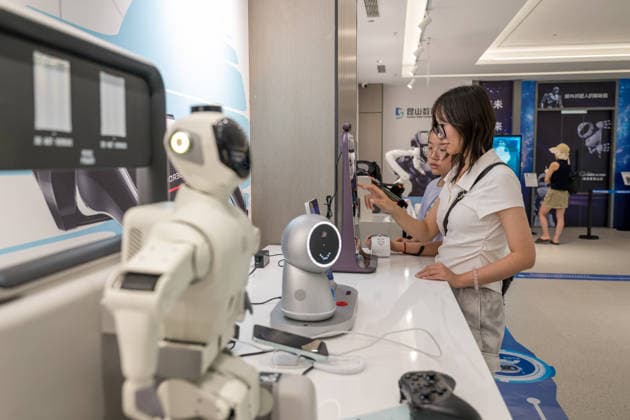 KUNSHAN, CHINA - JULY 19: People visit a robot 6S store on its opening day on July 19, 2026 in Kunshan, Jiangsu Province of China. The store offers integrated sales, spare parts, after-sales service, feedback, leasing, and customization services while serving as a hub for humanoid robots, drones, training, and industry incubation.  Copyright: xVCGx 111655192669