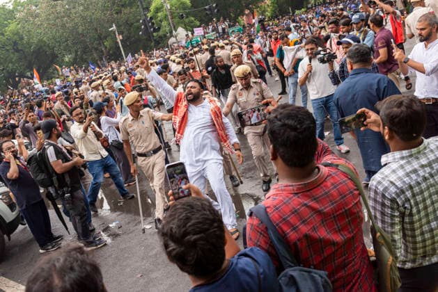July 20, 2026, New Delhi, Delhi, India: Supporters of India s Cockroach Janta Party (CJP) gather before a march to Parliament during a protest demanding the resignation of Education Minister Dharmendra Pradhan over alleged exam paper leaks. Members of the Rapid Action Force (RAF) are deployed at the protest site near Jantar Mantar in New Delhi, India. New Delhi India - ZUMAt180 20260720_zip_t180_018 Copyright: xJaixThakurx