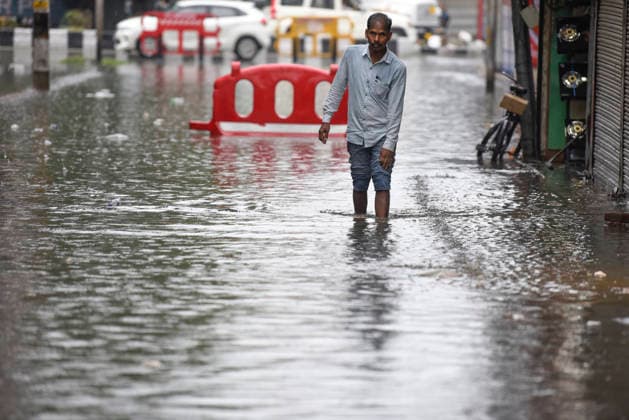 July 20, 2026, Srinagar, Jammu And Kashmir, India: A man wades through a waterlogged street following heavy monsoon rainfall in Srinagar.Torrential rain unleashed flash floods and landslides in Pir Panjal region of J&Ks Poonch and Rajouri districts Sunday, killing at least 14 people, leaving several missing and burying homes under walls of water, rock and mud that barrelled down mountain slopes. Officials said the toll could rise as rescuers searched for those trapped beneath debris. Srinagar India - ZUMAz120 20260720_zip_z120_004 Copyright: xBasitxZargarx