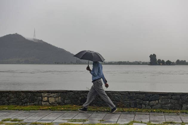 July 20, 2026, Srinagar, Jammu And Kashmir, India: A man walks during heavy rainfall in Srinagar.Torrential rain unleashed flash floods and landslides in Pir Panjal region of J&Ks Poonch and Rajouri districts Sunday, killing at least 14 people, leaving several missing and burying homes under walls of water, rock and mud that barrelled down mountain slopes. Officials said the toll could rise as rescuers searched for those trapped beneath debris. Srinagar India  - ZUMAz120 20260720_zip_z120_006 Copyright: xBasitxZargarx