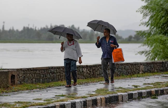 July 20, 2026, Srinagar, Jammu And Kashmir, India: People hold umbrella during heavy rainfall on the banks of Dal lake in Srinagar.Torrential rain unleashed flash floods and landslides in Pir Panjal region of J&Ks Poonch and Rajouri districts Sunday, killing at least 14 people, leaving several missing and burying homes under walls of water, rock and mud that barrelled down mountain slopes. Officials said the toll could rise as rescuers searched for those trapped beneath debris. Srinagar India - ZUMAz120 20260720_zip_z120_015 Copyright: xBasitxZargarx