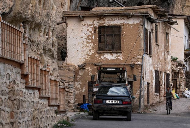 Historic grain granaries stand the test of time in Turkiye s Karaman KARAMAN, TURKIYE - JULY 20: A child rides a bicycle along a street in Taskale village of Karaman, Türkiye, on July 20, 2026. The village is home to centuries-old rock-carved grain granaries, hand-hewn into a single rock mass, which continue to preserve Anatolia s agricultural heritage with their distinctive architecture and natural storage conditions. Mahmut Serdar Alakus Anadolu Karaman Turkey. Editorial use only. Please get in touch for any other usage.  Copyright: x2026xAnadoluxMahmutxSerdarxAlakuÅüx