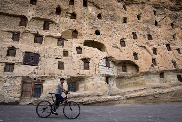 Historic grain granaries stand the test of time in Turkiye s Karaman KARAMAN, TURKIYE - JULY 20: A child rides a bicycle along a street in Taskale village of Karaman, Türkiye, on July 20, 2026. The village is home to centuries-old rock-carved grain granaries, hand-hewn into a single rock mass, which continue to preserve Anatolia s agricultural heritage with their distinctive architecture and natural storage conditions. Mahmut Serdar Alakus Anadolu Karaman Turkey. Editorial use only. Please get in touch for any other usage.  Copyright: x2026xAnadoluxMahmutxSerdarxAlakuÅüx