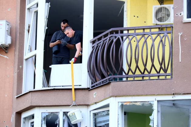 Two men remove debris through a shattered window in an apartment block in the Shevchenkivskyi district after a large-scale overnight Russian missile attack, Kyiv, Ukraine, July 19, 2026. The Russian army launched a massive attack on the capital with ballistic missiles. According to the State Emergency Service of Ukraine, an 89-year-old woman was killed and 15 people were injured. Falling debris and fires were reported in five districts of the city, while a direct hit was recorded at the underpass near Lukianivska metro station. (Photo by Pavlo Bahmut Ukrinform) Russian missile hits underground passage near Lukianivska metro station in Kyiv  Copyright: xPavloxBahmutx