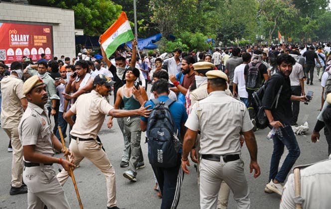 NEW DELHI, INDIA - JULY 20: Delhi Police carry out a mild lathi-charge to disperse supporters of the Cockroach Janta Party (CJP) after they gather in large numbers and breach security barricades near Parliament House on DR Rajendra Prasad Road on July 20, 2026 in New Delhi, India. The protesters were demanding the resignation of Union Education Minister Dharmendra Pradhan over alleged examination irregularities. (Photo by Ajay Aggarwal Hindustan Times) Delhi Police Use Lathi Charge And Tear Gas Shells To Disperse CJP Supporters During Their March To Parliament