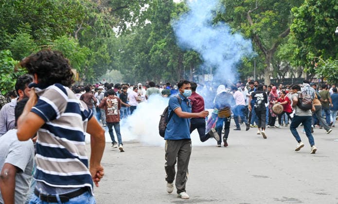 NEW DELHI, INDIA - JULY 20: Delhi Police use tear gas to disperse supporters of the Cockroach Janta Party (CJP) after they gather in large numbers and breach security barricades on DR Rajendra Prasad Road near Parliament House on July 20, 2026 in New Delhi, India. The protesters were demanding the resignation of Union Education Minister Dharmendra Pradhan over alleged examination irregularities. (Photo by Ajay Aggarwal Hindustan Times) Delhi Police Use Lathi Charge And Tear Gas Shells To Disperse CJP Supporters During Their March To Parliament