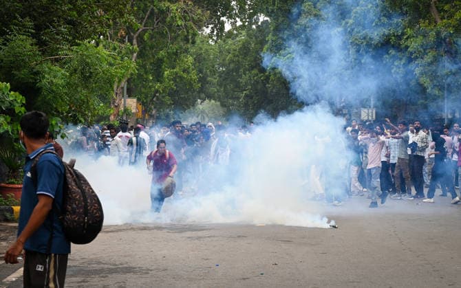 NEW DELHI, INDIA - JULY 20: Delhi Police use tear gas to disperse supporters of the Cockroach Janta Party (CJP) after they gather in large numbers and breach security barricades on DR Rajendra Prasad Road near Parliament House on July 20, 2026 in New Delhi, India. The protesters were demanding the resignation of Union Education Minister Dharmendra Pradhan over alleged examination irregularities. (Photo by Ajay Aggarwal Hindustan Times) Delhi Police Use Lathi Charge And Tear Gas Shells To Disperse CJP Supporters During Their March To Parliament