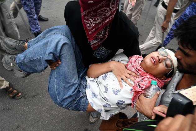NEW DELHI, INDIA - JULY 20: One of the supporters of the Cockroach Janta Party (CJP) faints due to the heat during a protest near Parliament House on July 20, 2026 in New Delhi, India. The protesters were demanding the resignation of Union Education Minister Dharmendra Pradhan over alleged examination irregularities. (Photo by Ajay Aggarwal Hindustan Times) Delhi Police Use Lathi Charge And Tear Gas Shells To Disperse CJP Supporters During Their March To Parliament