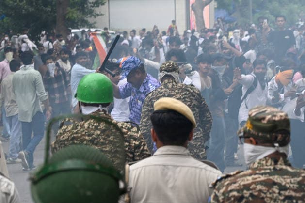 NEW DELHI, INDIA - JULY 20: Delhi Police use tear gas to disperse supporters of the Cockroach Janta Party (CJP) after they gather in large numbers and breach security barricades on DR Rajendra Prasad Road near Parliament House on July 20, 2026 in New Delhi, India. The protesters were demanding the resignation of Union Education Minister Dharmendra Pradhan over alleged examination irregularities. (Photo by Ajay Aggarwal Hindustan Times) Delhi Police Use Lathi Charge And Tear Gas Shells To Disperse CJP Supporters During Their March To Parliament