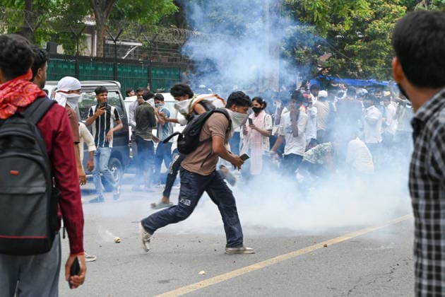NEW DELHI, INDIA - JULY 20: Delhi Police use tear gas to disperse supporters of the Cockroach Janta Party (CJP) after they gather in large numbers and breach security barricades on DR Rajendra Prasad Road near Parliament House on July 20, 2026 in New Delhi, India. The protesters were demanding the resignation of Union Education Minister Dharmendra Pradhan over alleged examination irregularities. (Photo by Ajay Aggarwal Hindustan Times) Delhi Police Use Lathi Charge And Tear Gas Shells To Disperse CJP Supporters During Their March To Parliament
