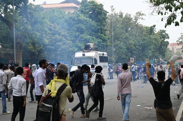 NEW DELHI, INDIA - JULY 20: Delhi Police use tear gas to disperse supporters of the Cockroach Janta Party (CJP) after they gather in large numbers and breach security barricades on DR Rajendra Prasad Road near Parliament House on July 20, 2026 in New Delhi, India. The protesters were demanding the resignation of Union Education Minister Dharmendra Pradhan over alleged examination irregularities. (Photo by Ajay Aggarwal Hindustan Times) Delhi Police Use Lathi Charge And Tear Gas Shells To Disperse CJP Supporters During Their March To Parliament