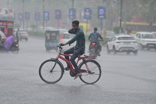 July 20, 2026, Prayagraj, Uttar Pradesh, India: Prayagraj: A youth paddle his cycle during Rain, in Prayagraj on Monday, July 20, 2026. Prayagraj India - ZUMAv115 20260720_zap_v115_039 Copyright: xPrabhatxKumarxVermax