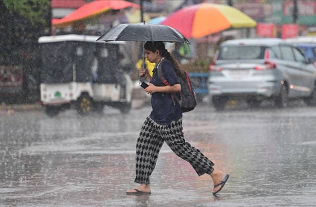 July 20, 2026, Prayagraj, Uttar Pradesh, India: Prayagraj: A women walks with an umbrella during Rain, in Prayagraj on Monday, July 20, 2026. Prayagraj India - ZUMAv115 20260720_zap_v115_041 Copyright: xPrabhatxKumarxVermax