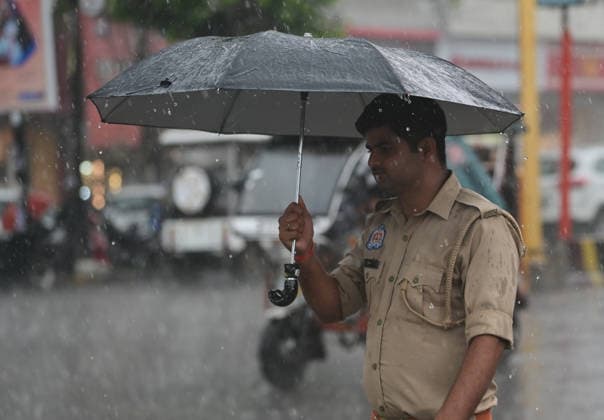 July 20, 2026, Prayagraj, Uttar Pradesh, India: Prayagraj: A policeman walks with an umbrella during Rain, in Prayagraj on Monday, July 20, 2026. Prayagraj India - ZUMAv115 20260720_zap_v115_042 Copyright: xPrabhatxKumarxVermax
