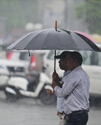 July 20, 2026, Prayagraj, Uttar Pradesh, India: Prayagraj: People share an umbrella during Rain, in Prayagraj on Monday, July 20, 2026. Prayagraj India - ZUMAv115 20260720_zap_v115_049 Copyright: xPrabhatxKumarxVermax