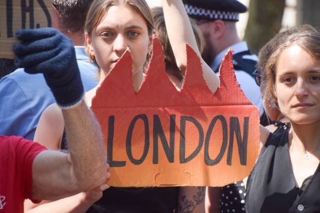 July 20, 2026, London, England, United Kingdom: A protester holds a London burning sign as climate activists from the group Fossil Free London stage a protest outside Downing Street against Rosebank and other oil and gas projects in the North Sea ahead of the arrival of Andy Burnham, who replaces Keir Starmer as the UK Prime Minister. London United Kingdom  - ZUMAv130 20260720_zip_v130_024 Copyright: xVukxValcicx