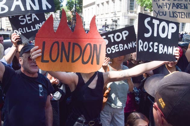 July 20, 2026, London, England, United Kingdom: A protester holds a London burning sign as climate activists from the group Fossil Free London stage a protest outside Downing Street against Rosebank and other oil and gas projects in the North Sea ahead of the arrival of Andy Burnham, who replaces Keir Starmer as the UK Prime Minister. London United Kingdom - ZUMAv130 20260720_zip_v130_034 Copyright: xVukxValcicx