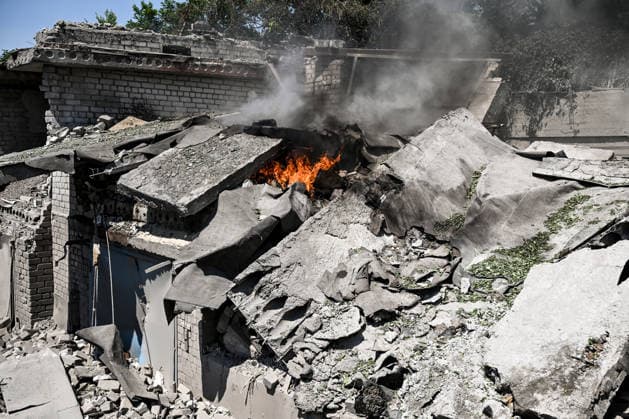 A fire continues in one of the garages destroyed by a Russian guided aerial bomb strike on a garage cooperative in the Voznesenivskyi district of Zaporizhzhia, Ukraine, July 20, 2026. The attack destroyed or damaged privately owned garages, while the blast wave and debris wrecked civilian cars. A woman was killed at the site of the strike, and five others were injured. (Photo by Dmytro Smolienko Ukrinform) Russian strike garage co-op in central Zaporizhzhia with guided bomb  Copyright: xDmytroxSmolienkox