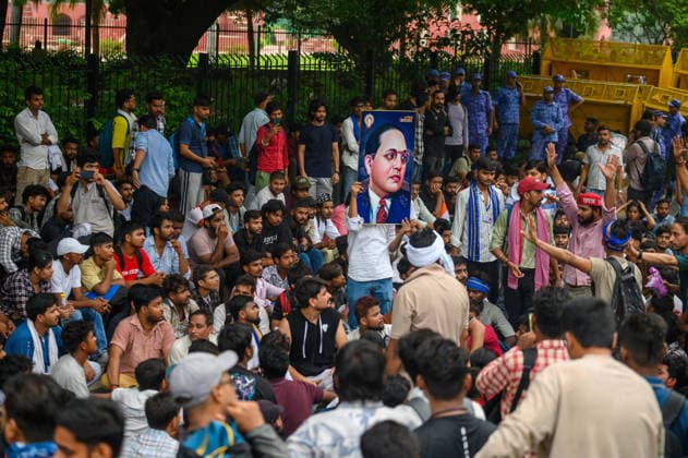 July 20, 2026, New Delhi, New Delhi, India: NEW DELHI, India Ã¢â‚¬ Protesters, some holding a portrait of B.R. Ambedkar, gather near a security barricade lined with police personnel and a water cannon vehicle at Jantar Mantar during demonstrations by the Cockroach Janata Party (CJP) demanding the resignation of Education Minister Dharmendra Pradhan over alleged irregularities in the NEET-UG exam, July 20, 2026. New Delhi India  - ZUMAm184 20260720_zip_m184_012 Copyright: xAnkitxRoyxMajumderx