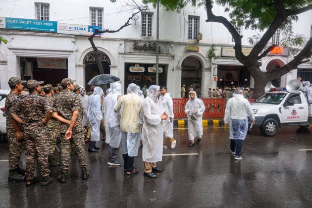 July 20, 2026, New Delhi, New Delhi, India: NEW DELHI, India Ã¢â‚¬ Police personnel in raincoats gather near Connaught Place as rain falls while security forces attempt to stop protesters from advancing further, during demonstrations by the Cockroach Janata Party (CJP) demanding the resignation of Education Minister Dharmendra Pradhan over alleged irregularities in the NEET-UG exam, July 20, 2026. New Delhi India - ZUMAm184 20260720_zip_m184_017 Copyright: xAnkitxRoyxMajumderx