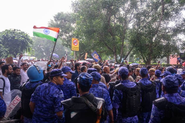 July 20, 2026, New Delhi, New Delhi, India: NEW DELHI, India Ã¢â‚¬ Rapid Action Force (RAF) personnel in riot gear stand in large numbers as protesters wave the national flag and raise slogans near Connaught Place, during demonstrations by the Cockroach Janata Party (CJP) demanding the resignation of Education Minister Dharmendra Pradhan over alleged irregularities in the NEET-UG exam, July 20, 2026. New Delhi India - ZUMAm184 20260720_zip_m184_019 Copyright: xAnkitxRoyxMajumderx